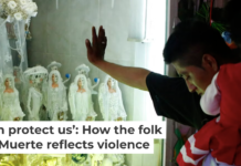 A devotee carrying his daughter rests his hand on the glass to an altar to La Santa Muerte in Tepito in Mexico City. AP Photo/Rebecca Blackwell